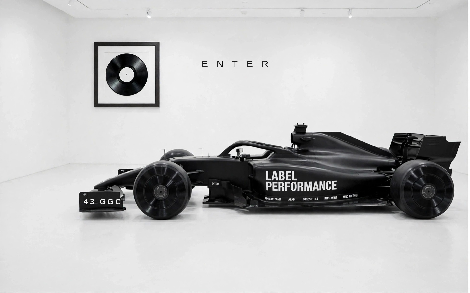 The all-black Label Performance Formula One car in a white gallery